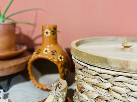 Hand-painted clay chiminea, terracotta pottery and woven baskets